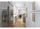 Gourmet kitchen with stainless steel refrigerator and seamless flow into dining area at 11830 Kingsbarns Ct, Las Vegas, NV 89141