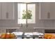 Bright, white kitchen with stainless steel appliances and sink with a view at 11830 Kingsbarns Ct, Las Vegas, NV 89141