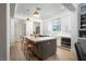Bright kitchen with hardwood floors, center island with seating, and modern appliances for easy cooking at 11830 Kingsbarns Ct, Las Vegas, NV 89141
