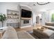 Cozy living room featuring a modern fireplace, built-in shelving, and a comfortable seating arrangement at 11830 Kingsbarns Ct, Las Vegas, NV 89141