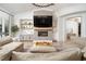 Bright living room with modern fireplace, built-in shelving, and hardwood floors, great for entertaining at 11830 Kingsbarns Ct, Las Vegas, NV 89141