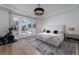 Serene main bedroom with luxury bed, stylish chandelier, and French doors leading to outdoor pool area at 11830 Kingsbarns Ct, Las Vegas, NV 89141