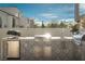 A detailed view of the stainless-steel outdoor kitchen with decorative tile backsplash at 11830 Kingsbarns Ct, Las Vegas, NV 89141
