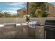 Close-up of the outdoor kitchen featuring stainless steel grill and sink, ideal for entertaining at 11830 Kingsbarns Ct, Las Vegas, NV 89141