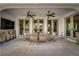 Charming outdoor patio features a dining area, ceiling fans, and access to the backyard at 11830 Kingsbarns Ct, Las Vegas, NV 89141