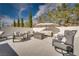 Relaxing patio with plush seating, an umbrella, and scenic backyard views at 11830 Kingsbarns Ct, Las Vegas, NV 89141