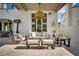 Cozy outdoor lounge area with stylish furniture, a pendant light, and backyard access at 11830 Kingsbarns Ct, Las Vegas, NV 89141