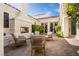 Welcoming backyard patio featuring an outdoor fireplace and comfortable seating arrangement at 11830 Kingsbarns Ct, Las Vegas, NV 89141