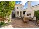Beautiful outdoor patio area with a stone fireplace and manicured landscaping at 11830 Kingsbarns Ct, Las Vegas, NV 89141