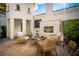 Outdoor patio with a stone fireplace, tiled brick flooring, and comfortable seating at 11830 Kingsbarns Ct, Las Vegas, NV 89141