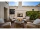 Picturesque patio space with fireplace, seating, and landscaped greenery at 11830 Kingsbarns Ct, Las Vegas, NV 89141