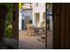Private brick patio with stone accents and a cozy seating area for outdoor relaxation at 11830 Kingsbarns Ct, Las Vegas, NV 89141