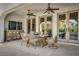 Charming outdoor patio features a dining area, ceiling fans, and access to the backyard at 11830 Kingsbarns Ct, Las Vegas, NV 89141