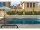 Beautiful backyard pool with sleek water features and privacy landscaping at 11830 Kingsbarns Ct, Las Vegas, NV 89141