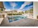 Serene backyard pool with manicured landscaping, a spa, and an umbrella at 11830 Kingsbarns Ct, Las Vegas, NV 89141