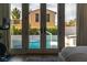 Pool view from the main bedroom through French doors, offering a glimpse of the backyard oasis at 11830 Kingsbarns Ct, Las Vegas, NV 89141