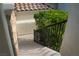 A stone staircase with metal railing descends alongside lush greenery at 11830 Kingsbarns Ct, Las Vegas, NV 89141