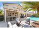 Inviting backyard features a sparkling pool, covered patio with outdoor seating, and a built-in bar, perfect for entertaining at 1291 Rolling Sunset St, Henderson, NV 89052