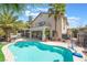 Expansive backyard featuring a private pool, covered patio with bar, and an upper level balcony on the residence at 1291 Rolling Sunset St, Henderson, NV 89052