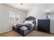 This bedroom has carpeted floors, a large bed and a side table at 1291 Rolling Sunset St, Henderson, NV 89052