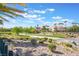 Scenic view of community landscaping with lush greenery, trees, and well-maintained lawns under a bright blue sky at 1291 Rolling Sunset St, Henderson, NV 89052