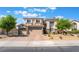 A two-story home with a three-car garage and desert landscaping at 1291 Rolling Sunset St, Henderson, NV 89052