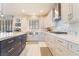 Modern kitchen with white cabinets, stainless steel appliances, and large island at 1291 Rolling Sunset St, Henderson, NV 89052