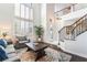 Bright living room with high ceilings, large windows, and an open staircase at 1291 Rolling Sunset St, Henderson, NV 89052