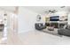 Bright living room with fireplace, ceiling fan, modern decor, and sliding glass doors to the patio at 1291 Rolling Sunset St, Henderson, NV 89052