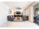 Spacious living room with fireplace, ceiling fan, modern decor, and sliding glass doors to the patio at 1291 Rolling Sunset St, Henderson, NV 89052