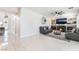 Bright living room with tile floors, a fireplace, a ceiling fan, and comfortable leather couches at 1291 Rolling Sunset St, Henderson, NV 89052