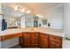 Large main bathroom with dual sinks, vanity area, and cherry wood cabinetry at 1291 Rolling Sunset St, Henderson, NV 89052