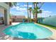 Refreshing swimming pool surrounded by well-kept patio area, tall palm trees, and a grassy section at 1291 Rolling Sunset St, Henderson, NV 89052