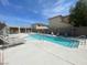 A sparkling community pool with lounge chairs, a hot tub, and ample space for relaxation at 137 Coronation Ave, Las Vegas, NV 89123