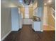 Bright kitchen featuring white cabinets, stainless steel appliances, and wood-look tile flooring at 137 Coronation Ave, Las Vegas, NV 89123
