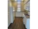 Bright kitchen featuring white cabinets, granite countertops, and wood-look tile flooring at 137 Coronation Ave, Las Vegas, NV 89123