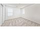 Cozy bedroom featuring neutral carpet, bright windows, and a closet with sliding doors at 156 Fulgora St, Henderson, NV 89074
