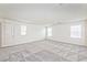 Spacious room with natural light, featuring neutral carpet, walls, and multiple windows at 156 Fulgora St, Henderson, NV 89074