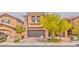 Charming two-story home with a gray two-car garage and well-maintained landscaping at 156 Fulgora St, Henderson, NV 89074