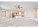 Bright living room featuring neutral carpet, fan and an open floor plan at 156 Fulgora St, Henderson, NV 89074