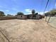 Spacious backyard with a covered patio, lots of open dirt, and a privacy fence at 1836 Mcdaniel St, North Las Vegas, NV 89030