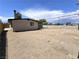 Spacious backyard with a covered patio, lots of open dirt, and a privacy fence at 1836 Mcdaniel St, North Las Vegas, NV 89030