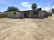 Spacious backyard with a covered patio, lots of open dirt, and a privacy fence at 1836 Mcdaniel St, North Las Vegas, NV 89030