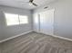 Bedroom featuring a large window, gray walls and carpet, and a closet with bi-fold doors at 1836 Mcdaniel St, North Las Vegas, NV 89030