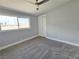 Bedroom featuring neutral gray walls, carpet, a bright window and a closet with bi-fold doors at 1836 Mcdaniel St, North Las Vegas, NV 89030