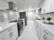 Updated kitchen with white cabinets, stainless steel appliances, and a modern aesthetic at 1836 Mcdaniel St, North Las Vegas, NV 89030