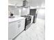 Modern kitchen showcasing stainless steel appliances, sleek white cabinetry, and contemporary marble floors at 1836 Mcdaniel St, North Las Vegas, NV 89030