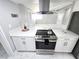 Modern kitchen featuring stainless steel appliances, white cabinetry, and marble-look flooring at 1836 Mcdaniel St, North Las Vegas, NV 89030