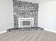 Cozy living room with stone fireplace, carpet, and natural light at 1836 Mcdaniel St, North Las Vegas, NV 89030