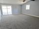 Open-concept living room featuring sliding glass door and plush carpeting at 1836 Mcdaniel St, North Las Vegas, NV 89030
